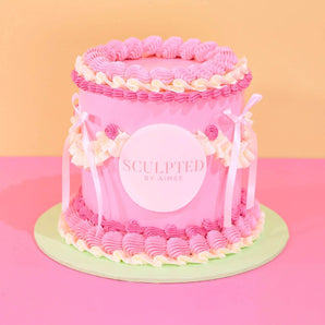 Corporate Vintage Cake with Logo - Tonal Colour decorated in pink icing with edible logo plaque and ribbon accents.